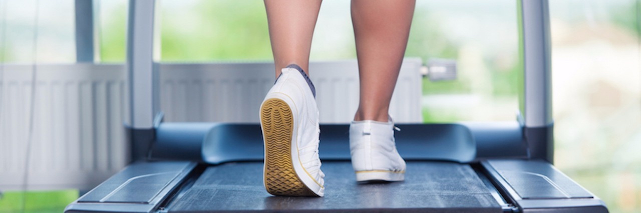 Accepting My Body While Recovering From an Eating Disorder woman walking on treadmill