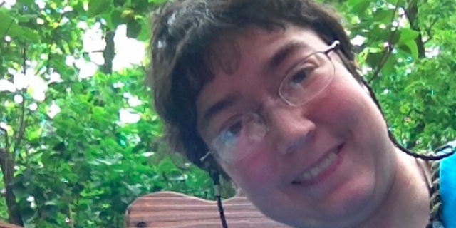 What I Want People to Know About Living With Gastroparesis Contributor, a woman with short hair and glasses, outside on a deck surrounded by trees