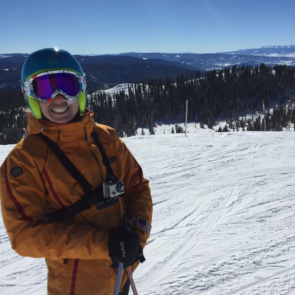 Woman on a mountain going skiing. 