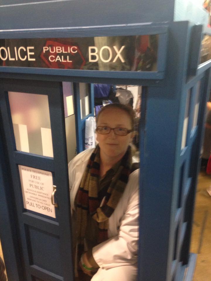 A woman in a phone booth. 