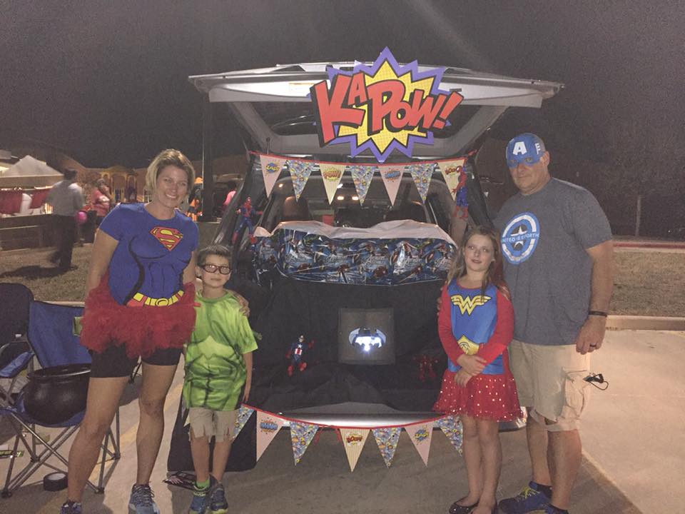 A family dressed like superheroes. 