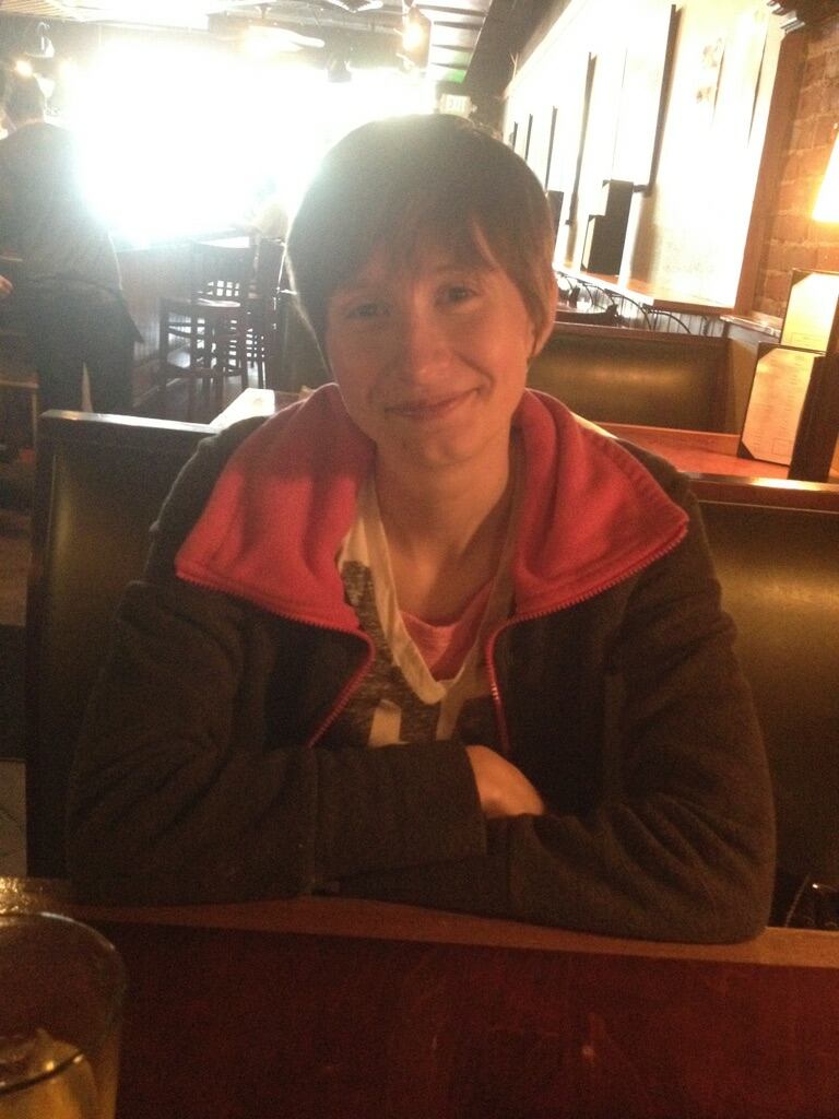 A young woman in a restaurant booth