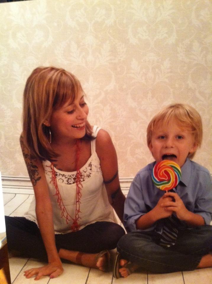 A woman and her son, who's holding a lollipop. 