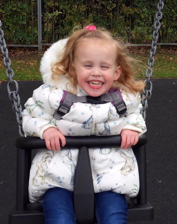 A young girl on a swing. 