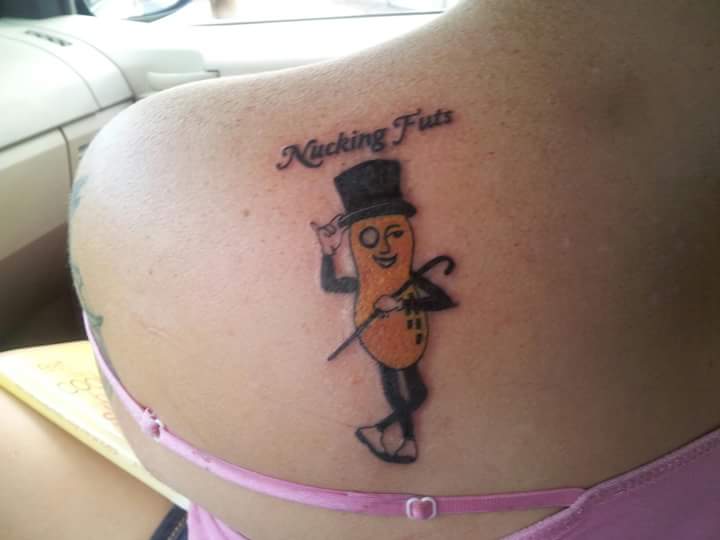 A tattoo of Mr. Peanut and the words "Nucking Futs" above it