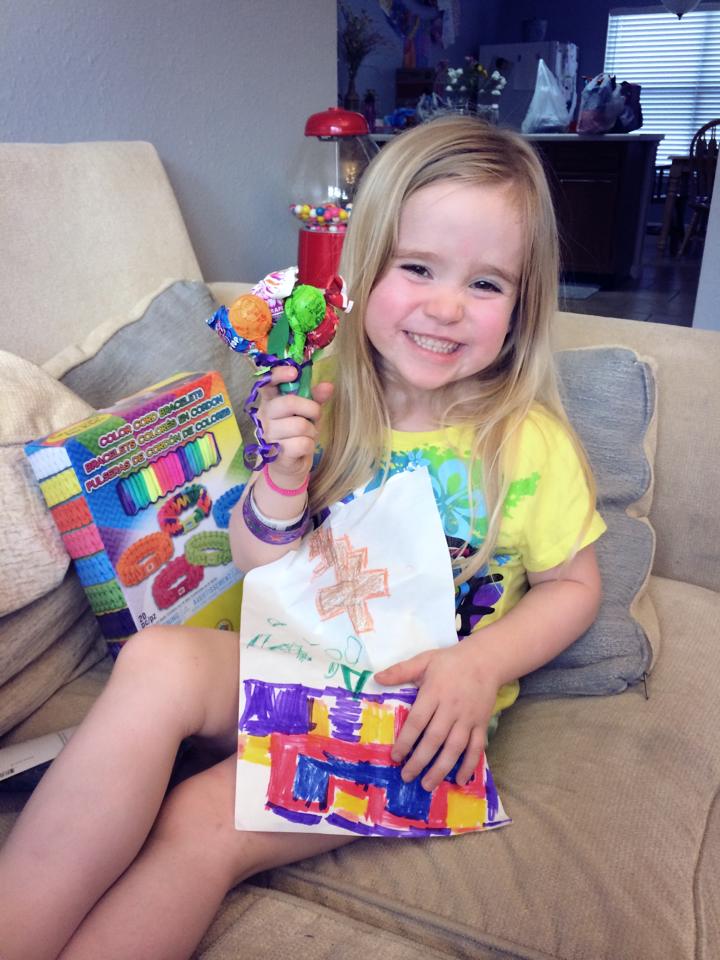 Little girl holding toys. 