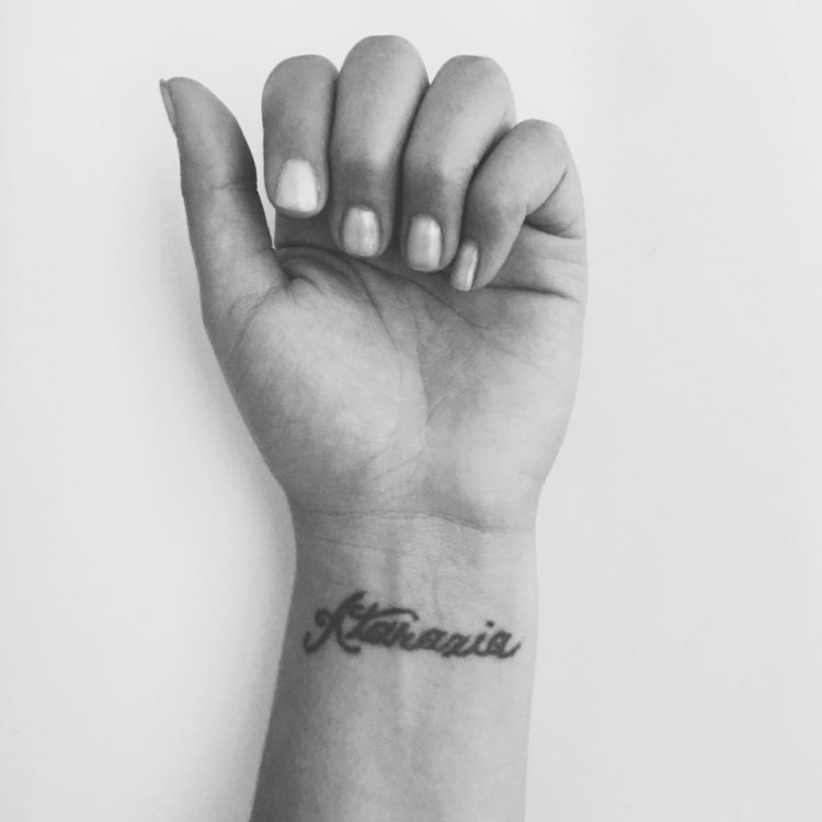 Tattoo of the word "ataraxia" written on wrist