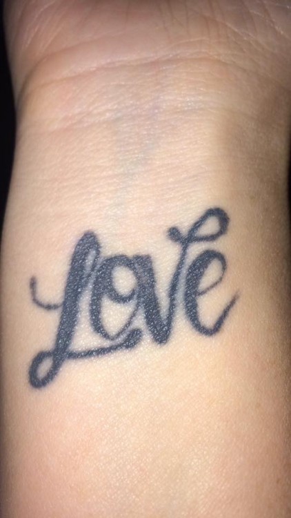 A tattoo of the word "Love"