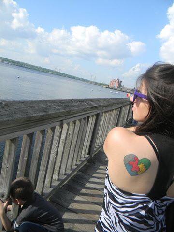 A tattoo made of the colors gray, red, blue, green and yellow