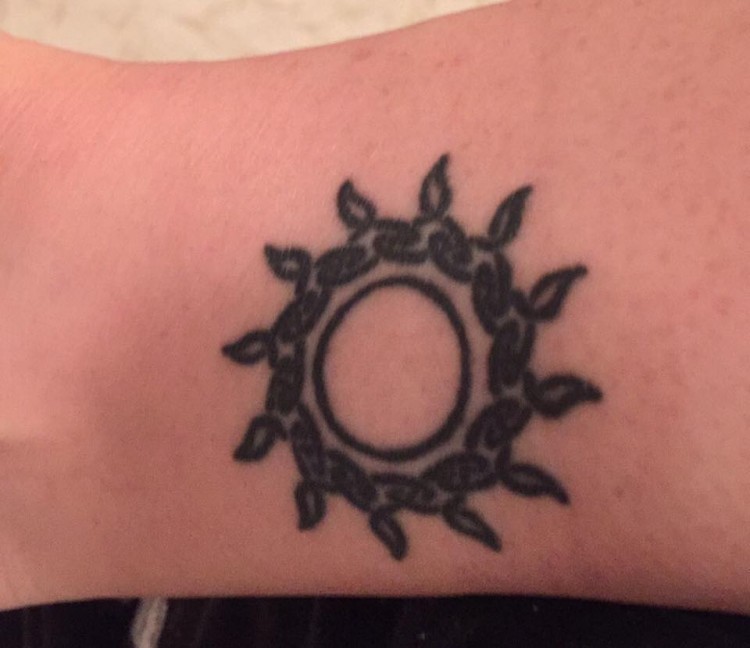 A tattoo of a Celtic sun