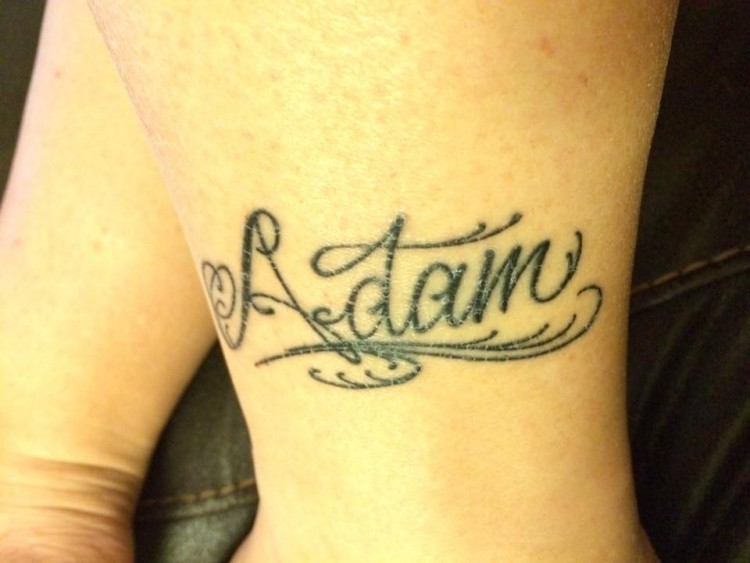 A tattoo of the name "Adam"