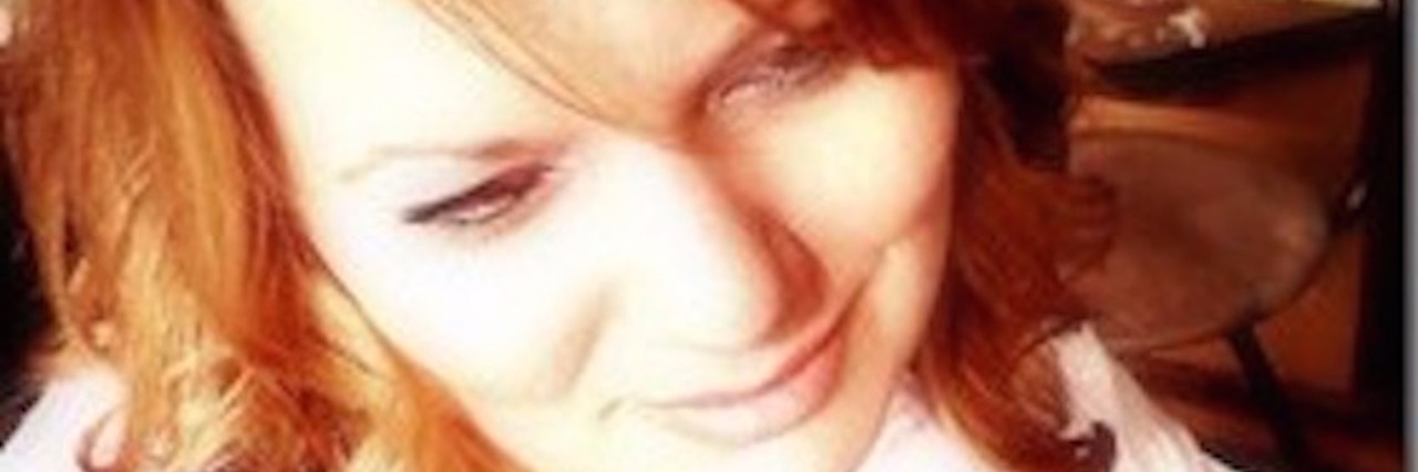 Living With Fibromyalgia Has Invisible Side the Public Doesn't See woman in pink shirt smiling