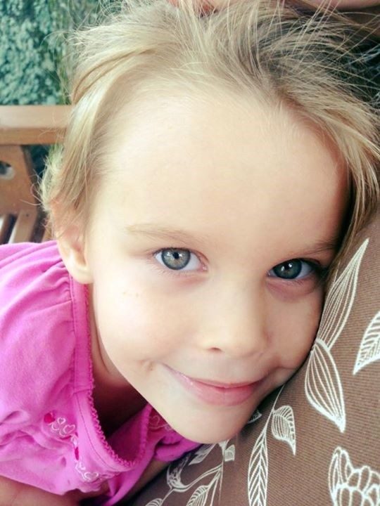 Author's daughter with PANDAS smiling and looking at camera.