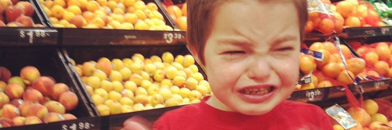 Woman Connects With a Special Needs Dad Over Their Nonverbal Children Kathy's son Isaac in the grocery store