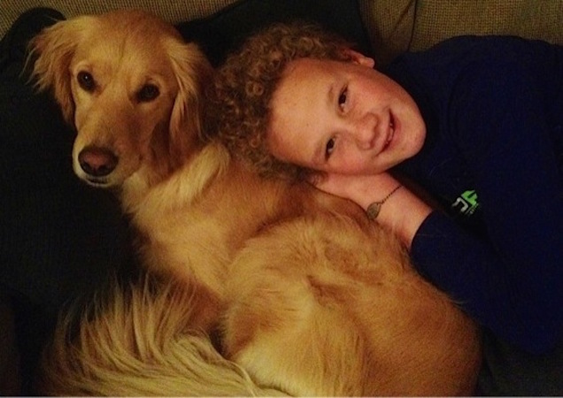 boy laying next to his dog