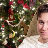 woman sitting by christmas tree
