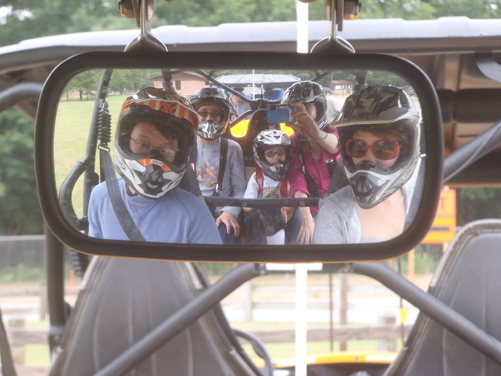 family off-roading in a dune buggy