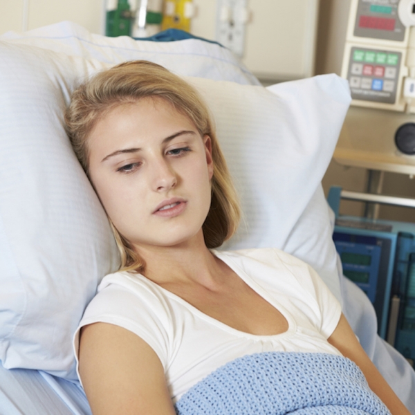 teenage girl in hospital bed