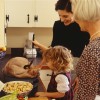 Grandmother mother and granddaughter (4-5) preparing thanksgiving turkey