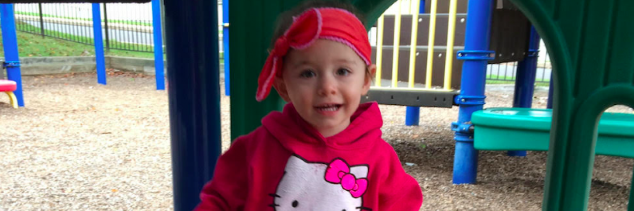 When Your Child Has Epilepsy, a Lot Can Happen in 30 Seconds... or Less Contributor's young daughter at smiling playground and wearing a pink Hello Kitty shirt