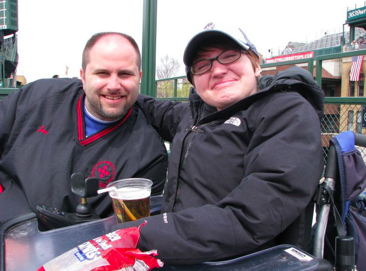 woman in a wheelchair with her arm around a man