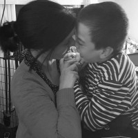 Mom touching foreheads with son