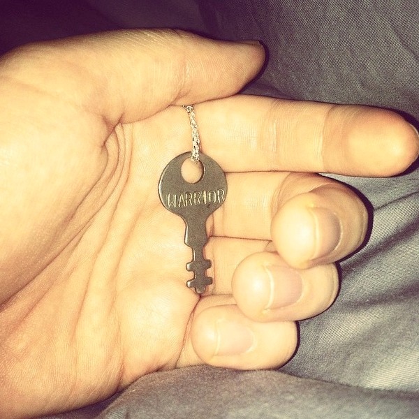 hand holding key that says warrior