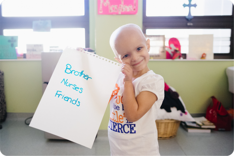 patient holds sign saying "brother, nurses, friends."