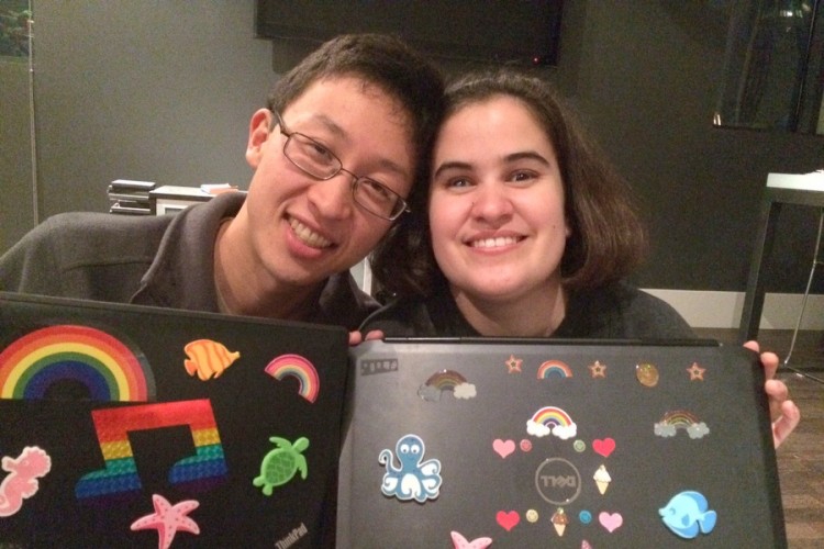 Eric and Caitlin decorating laptops with tactile stickers.