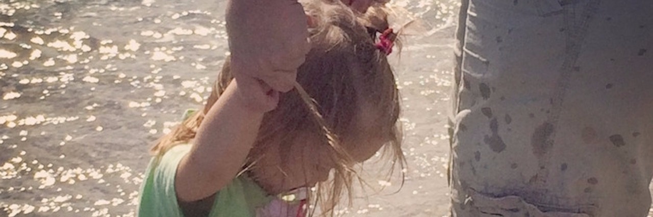 To the Woman Who Touched My Daughter With Sensory Processing Disorder Briann's daughter standing in water