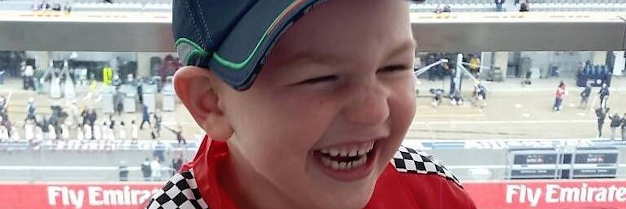 Struggling With the Terminal Aspect of Vanishing White Matter Disease young boy laughing and wearing racing gear