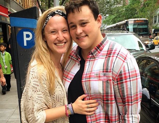 young woman wearing headband and hugging her boyfriend