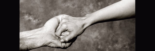 black and white photo of hands grasping each other