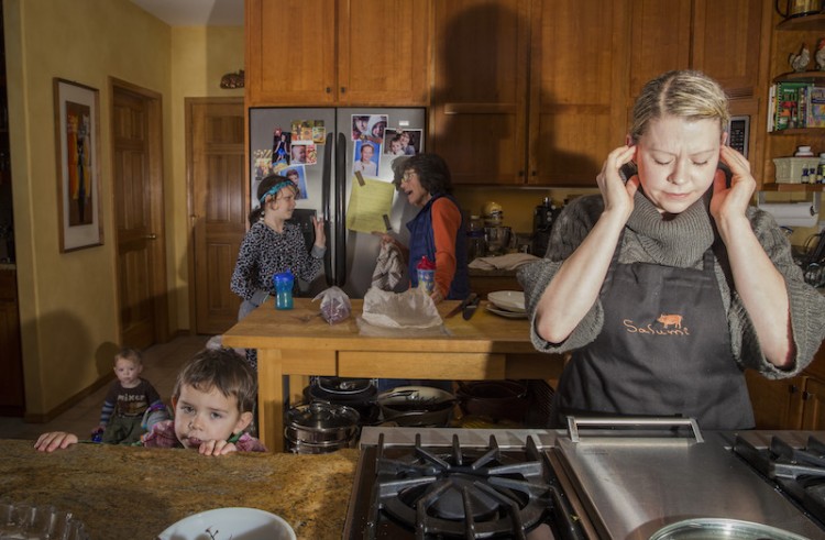 Woman bothered by noise in kitchen