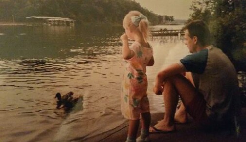girl and dad looking at lake