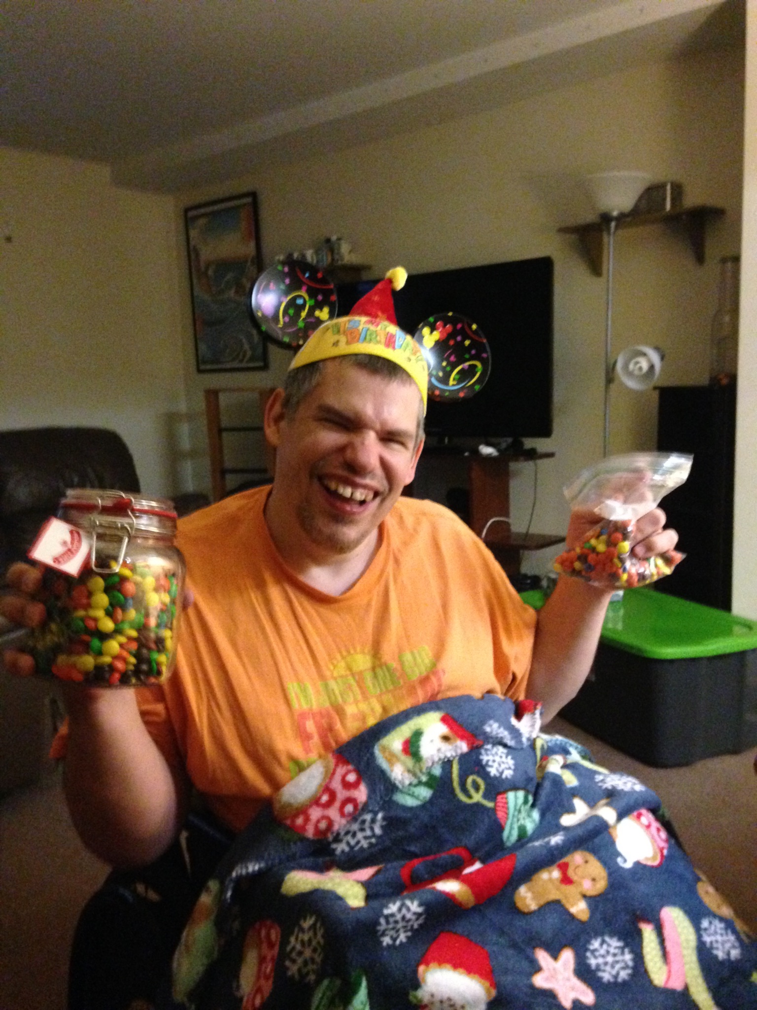 Mandy's friend Bill holding a jar of Reese's Pieces and M&M's