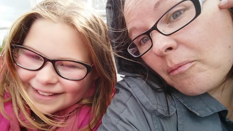 Michelle and her daughter. They're both wearing dark rimmed glasses and are smiling.