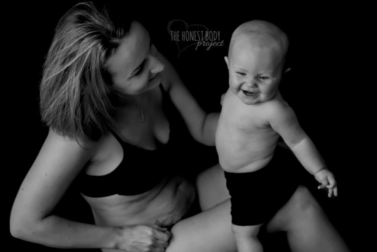 A smiling mom plays with her young son