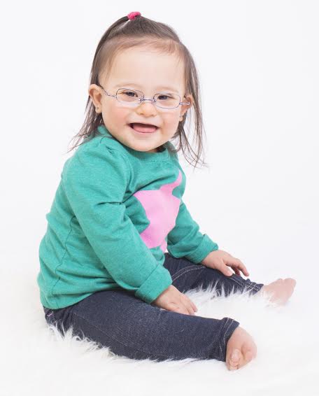 A young model named with Down syndrome named Guilianne. She's wearing glasses. 