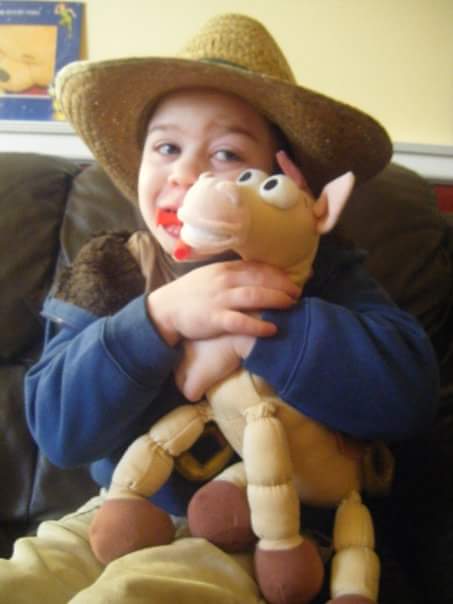 little boy holding a toy