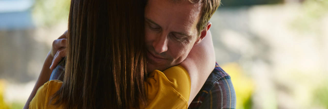 When You’re the Wife of a Man With Depression photo of a husband and wife holding each other in a supportive hug