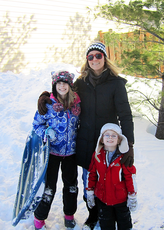 mom and her children outside in the snow