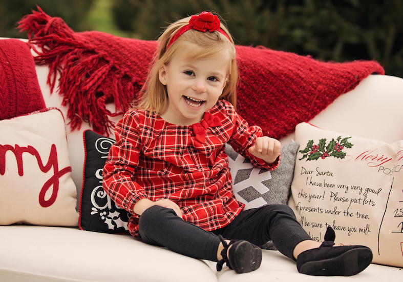 Girl sitting on a couch outdoors