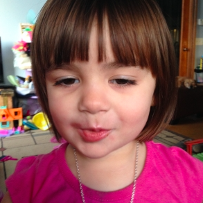 girl wearing pink shirt and short brown hair