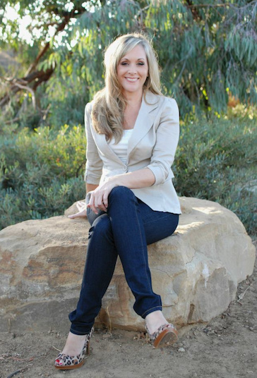 woman sitting on a rock outside