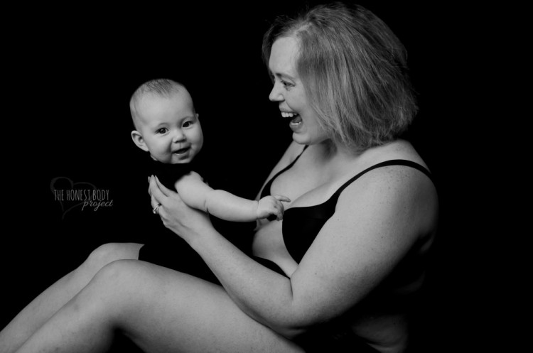 Mom smiles as she holds her baby