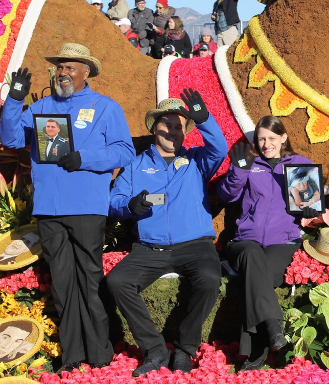 three people sitting on float and waving