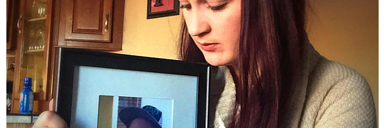 Please Don't Ask a Grieving Parent to 'Let It Go' Mother holds framed photo of her young son who has passed away