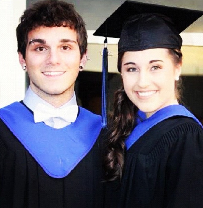 Boy and girl wearing cap and gown