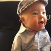 Toddler wearing a cap and button-down shirt